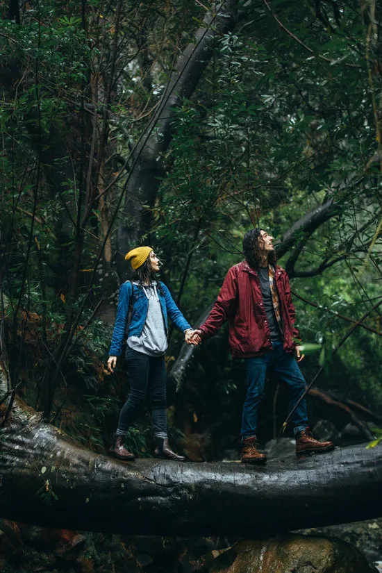 Couple hiking in forest on a rainy day