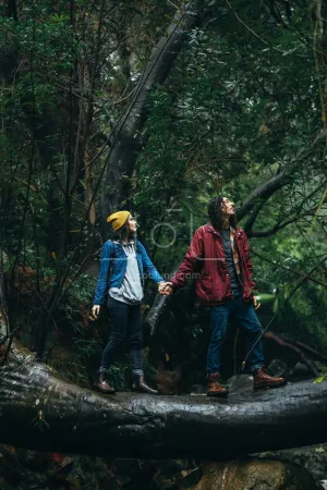 Couple hiking in forest on a rainy day