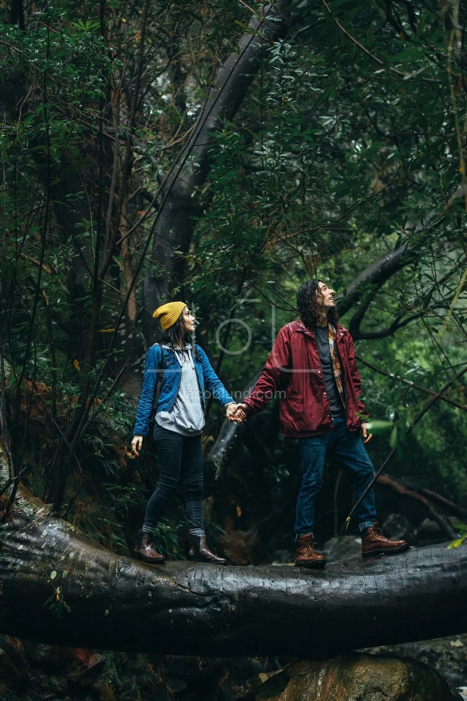 Couple hiking in forest on a rainy day